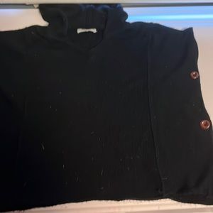 Black knitted poncho sweater.